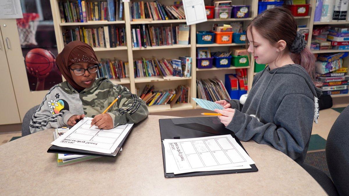 students writing on worksheets